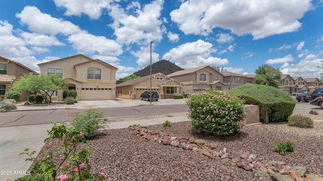 1821 E Patrick Ln, Phoenix, AZ 85024 - mediterranean / spanish-style house with concrete driveway, an attached garage, a residential view, and stucco siding