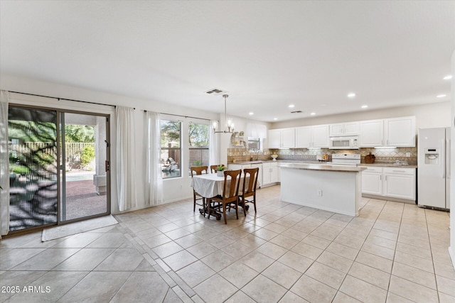 1821 E Patrick Ln, Phoenix, AZ 85024 - kitchen featuring white appliances, plenty of natural light, decorative backsplash, white cabinets, and recessed lighting