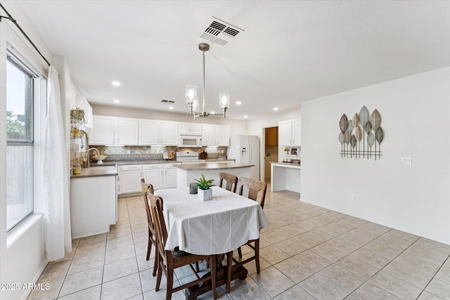 1821 E Patrick Ln, Phoenix, AZ 85024 - dining area with light tile patterned floors and recessed lighting