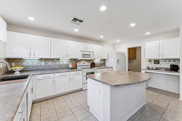 1821 E Patrick Ln, Phoenix, AZ 85024 - kitchen with white appliances, a sink, light tile patterned floors, a center island, and recessed lighting