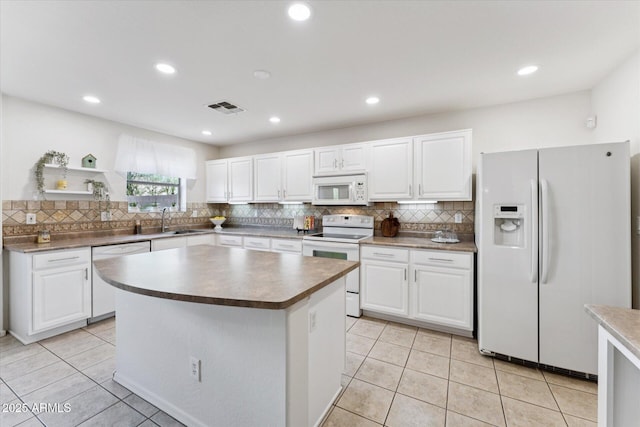 1821 E Patrick Ln, Phoenix, AZ 85024 - kitchen featuring white appliances, a sink, light tile patterned floors, backsplash, and recessed lighting