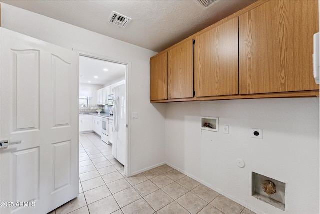 1821 E Patrick Ln, Phoenix, AZ 85024 - laundry area featuring washer hookup, cabinet space, hookup for an electric dryer, hookup for a gas dryer, and light tile patterned floors