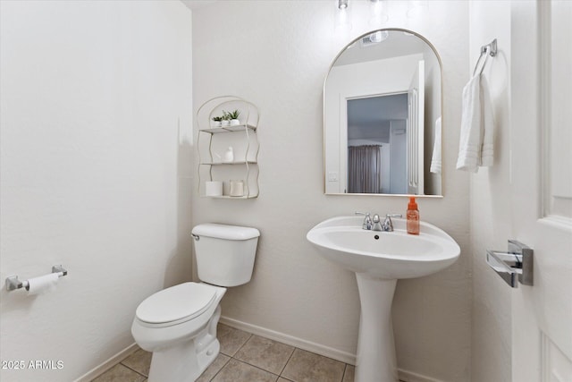 1821 E Patrick Ln, Phoenix, AZ 85024 - bathroom with toilet, tile patterned floors, a sink, and baseboards