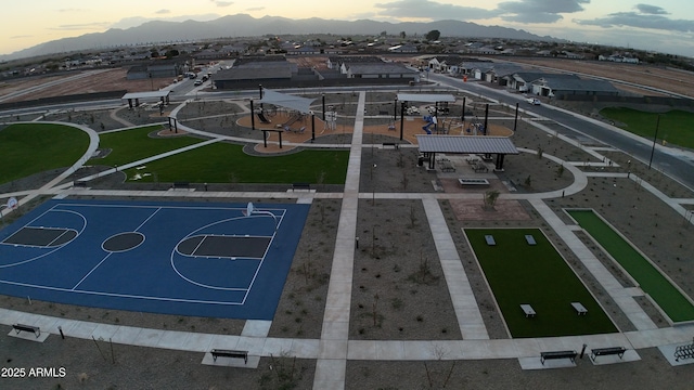 aerial view at dusk featuring a mountain view