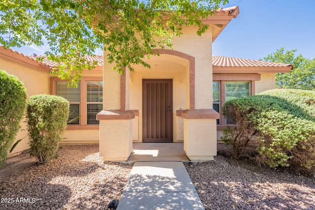 3665 E Thames Way, San Tan Valley, AZ 85140 - view of exterior entry with a tiled roof and stucco siding