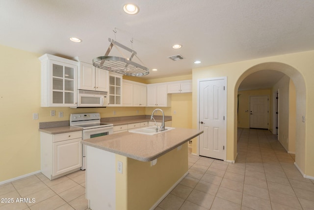 3665 E Thames Way, San Tan Valley, AZ 85140 - kitchen featuring white appliances, a sink, baseboards, light tile patterned floors, and white cabinetry