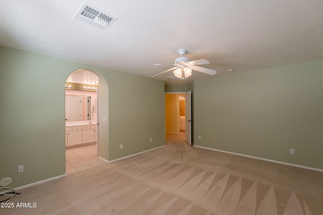 3665 E Thames Way, San Tan Valley, AZ 85140 - empty room featuring light colored carpet, arched walkways, a ceiling fan, and baseboards