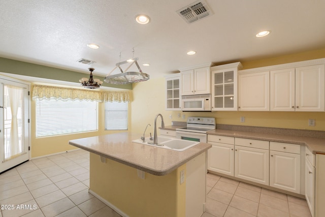3665 E Thames Way, San Tan Valley, AZ 85140 - kitchen featuring white appliances, a sink, light tile patterned floors, white cabinets, and recessed lighting