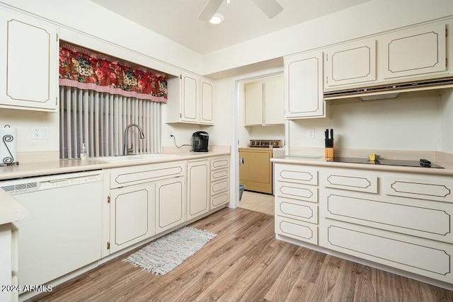 kitchen featuring light wood-type flooring, white dishwasher, sink, white cabinets, and washer / clothes dryer