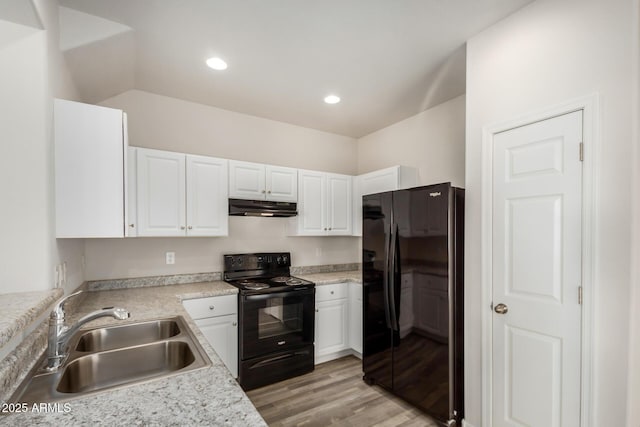 kitchen featuring white cabinetry, black appliances, under cabinet range hood, light countertops, and a sink