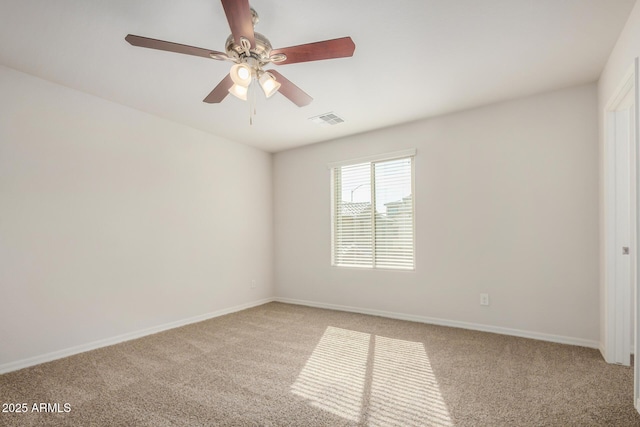 carpeted empty room featuring visible vents, baseboards, and a ceiling fan