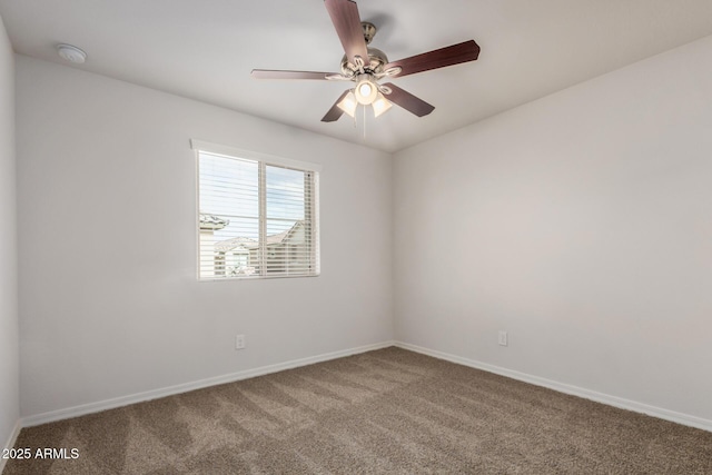 spare room with ceiling fan, baseboards, and carpet floors