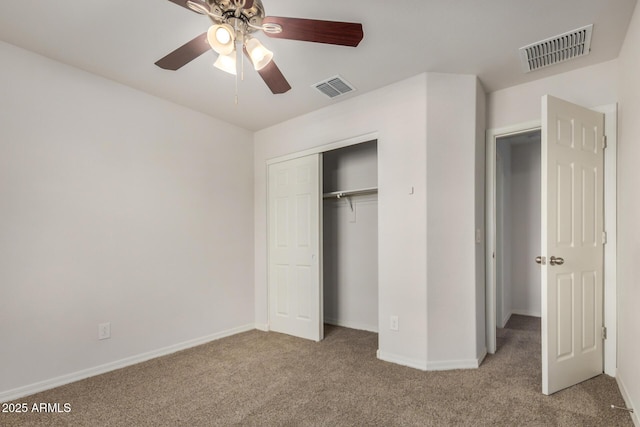 unfurnished bedroom featuring visible vents, baseboards, carpet flooring, and a closet