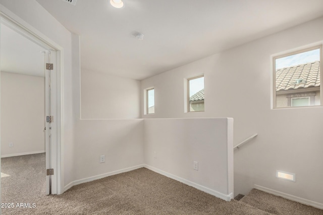 carpeted spare room with baseboards