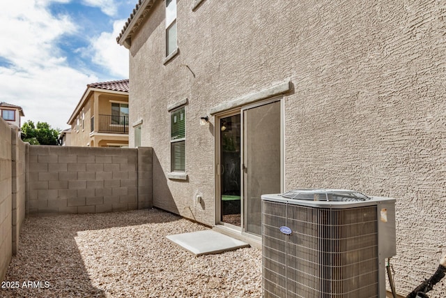 exterior space featuring central air condition unit and a fenced backyard