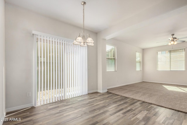 unfurnished room with wood finished floors, ceiling fan with notable chandelier, and baseboards