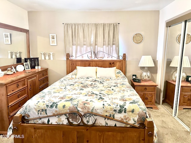 bedroom with a closet and light colored carpet