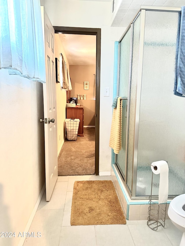 bathroom with tile patterned floors and an enclosed shower