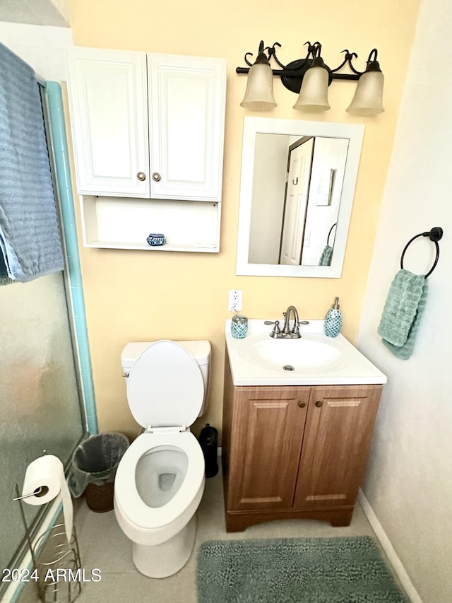 bathroom with tile patterned flooring, vanity, and toilet