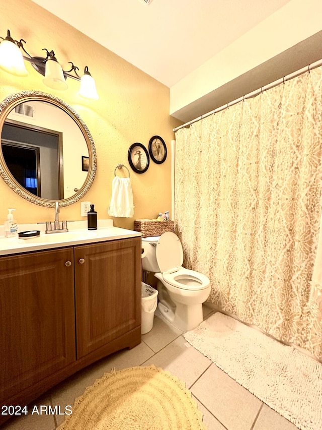 bathroom with tile patterned flooring, vanity, and toilet