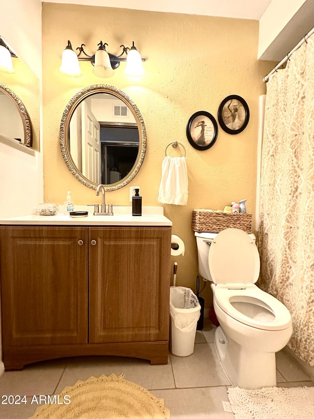 bathroom featuring tile patterned floors, vanity, and toilet