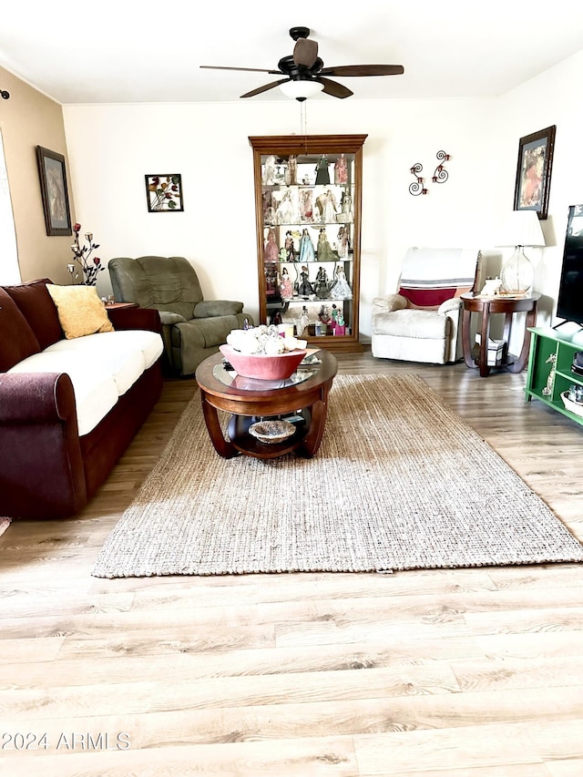 living room featuring ceiling fan and light hardwood / wood-style flooring