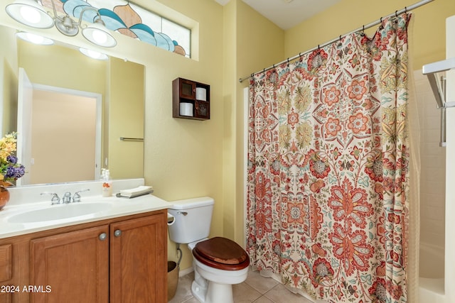 bathroom with tile patterned flooring, vanity, and toilet