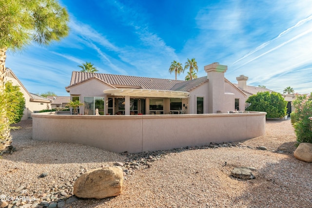 rear view of house featuring a pergola