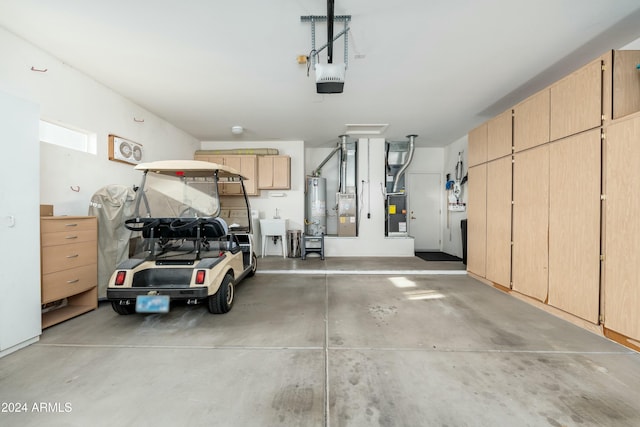 garage with gas water heater, sink, and a garage door opener