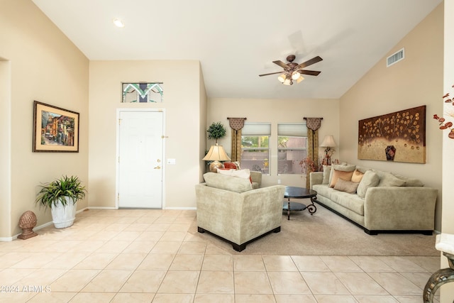 tiled living room featuring ceiling fan and vaulted ceiling