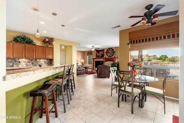 tiled dining area featuring ceiling fan