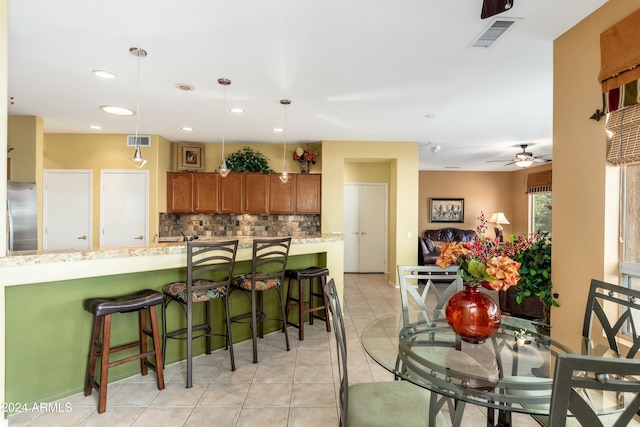 tiled dining area featuring ceiling fan