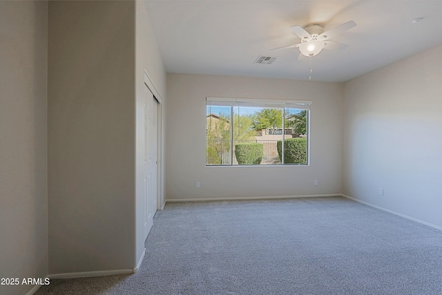 unfurnished room featuring ceiling fan and light carpet