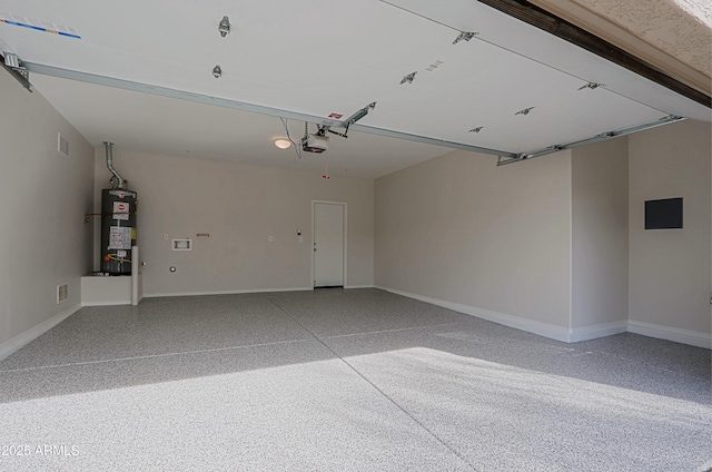 garage featuring gas water heater and a garage door opener