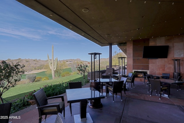 view of patio with a large fireplace