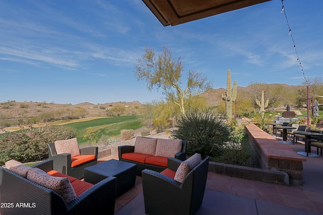 view of patio / terrace with an outdoor living space and a mountain view