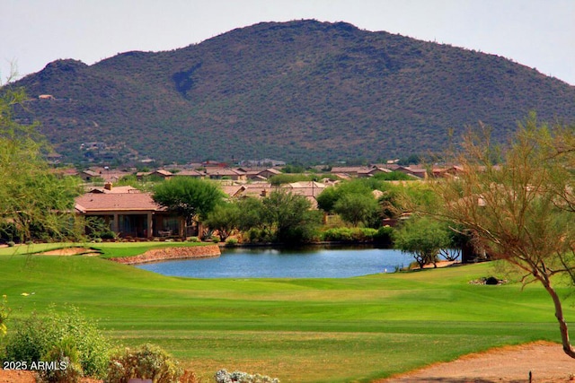 surrounding community with a water and mountain view and a yard