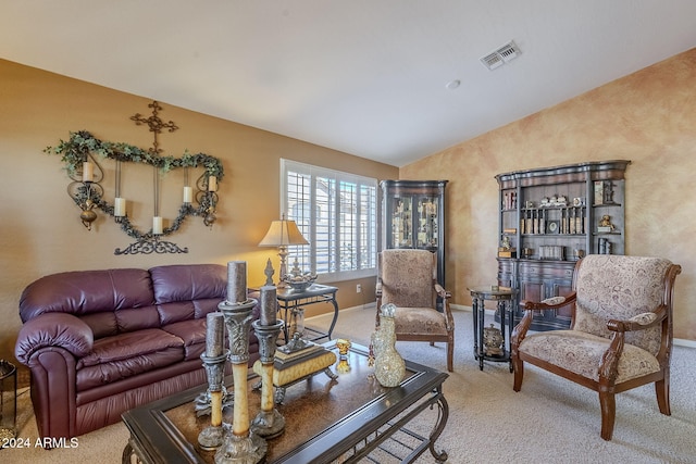 carpeted living room with lofted ceiling