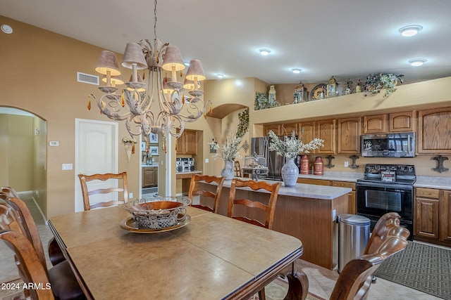 dining room with a high ceiling and an inviting chandelier