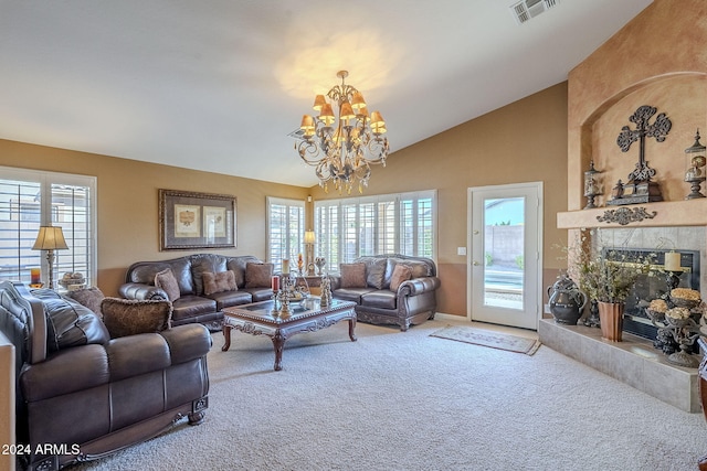 living room with a fireplace, a wealth of natural light, and an inviting chandelier