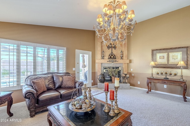 carpeted living room featuring an inviting chandelier, a large fireplace, and lofted ceiling