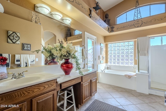 bathroom featuring shower with separate bathtub, vanity, and tile patterned floors