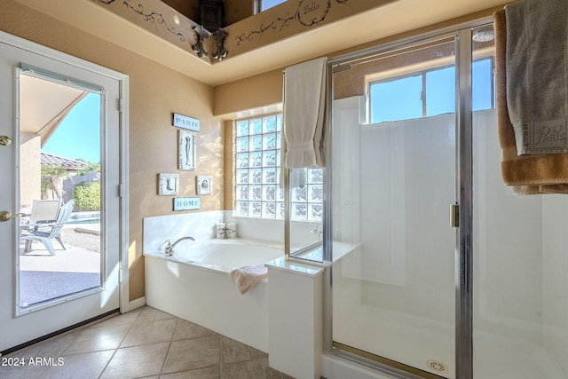 bathroom with tile patterned floors and shower with separate bathtub