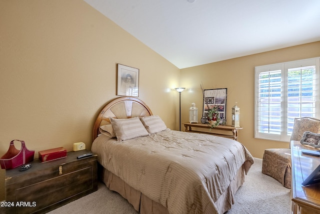 carpeted bedroom with vaulted ceiling