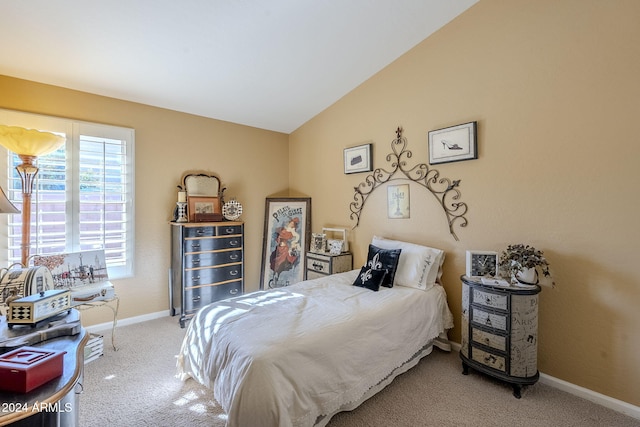 bedroom with vaulted ceiling and carpet floors