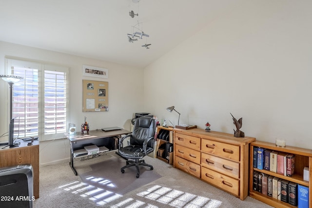 office area featuring lofted ceiling and light colored carpet