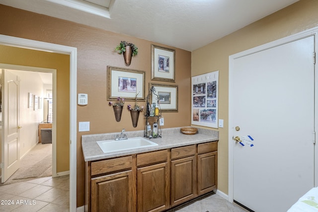 bathroom with vanity, tile patterned floors, and a textured ceiling