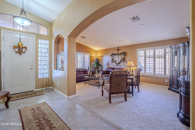 tiled entrance foyer featuring a wealth of natural light and vaulted ceiling