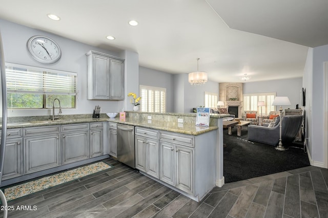 kitchen featuring gray cabinets, pendant lighting, dishwasher, sink, and plenty of natural light