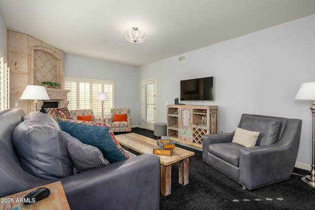 living room with a fireplace and carpet floors